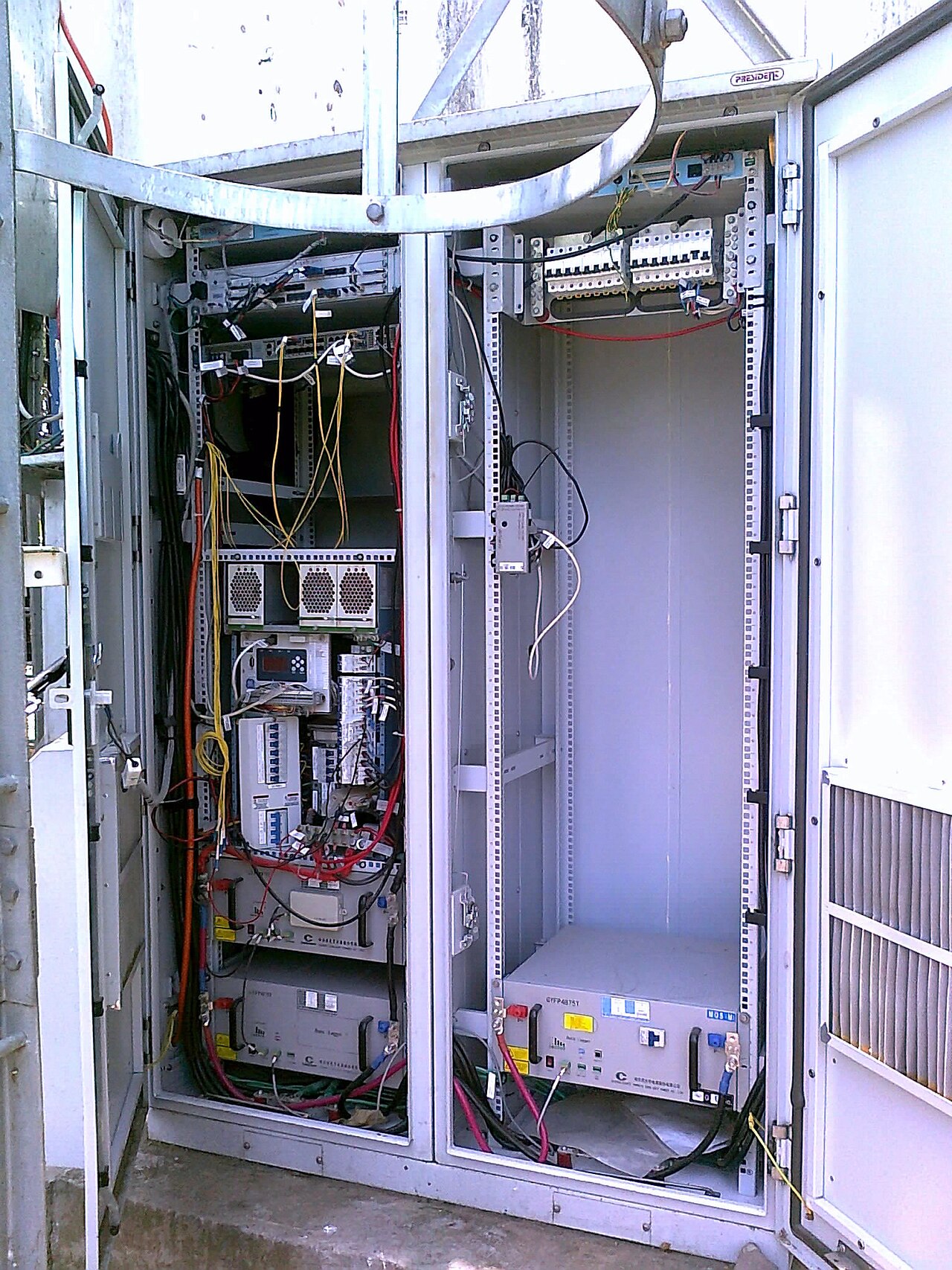 A GSM base transceiver station cell tower with sector antennas.